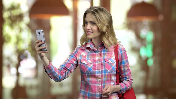 Attractive Girl in Casual Cloth Taking Selfie Using Her Smartphone
