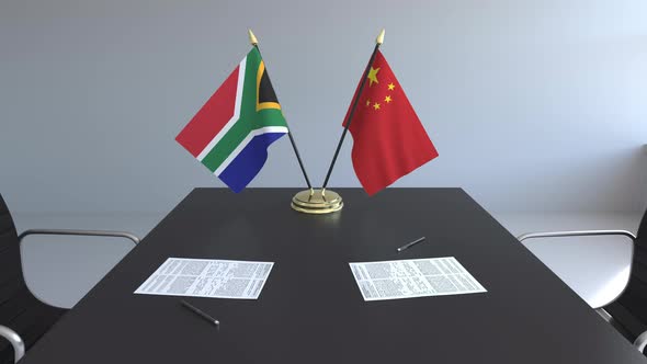 Flags of South Africa and China on the Table alt