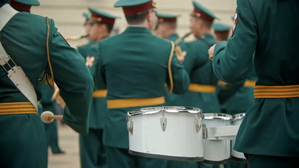 A Wind Instrument Military Parade - People in Green Costumes Playing Drums