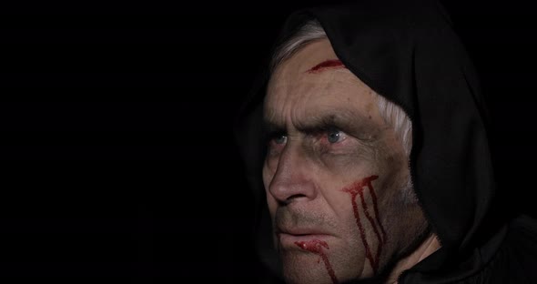 Old Executioner Halloween Makeup and Costume. Elderly Man with Blood on His Face