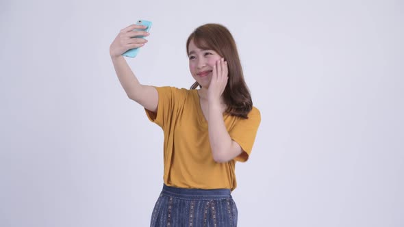 Happy Young Asian Woman Taking Selfie