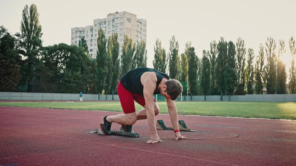 Young Male Athlete Preparing for the Start of the Marathon at the Urban Stadium