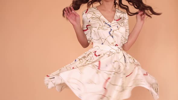 Girl in While Light Dress and Twirling Around in Studio