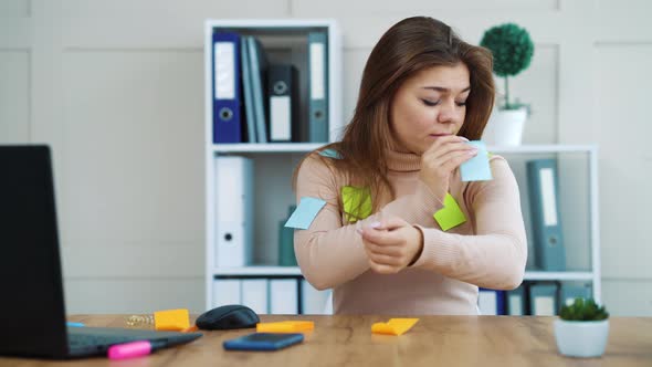 Tired Office Girl Ungluing Stickers From Her Clothes