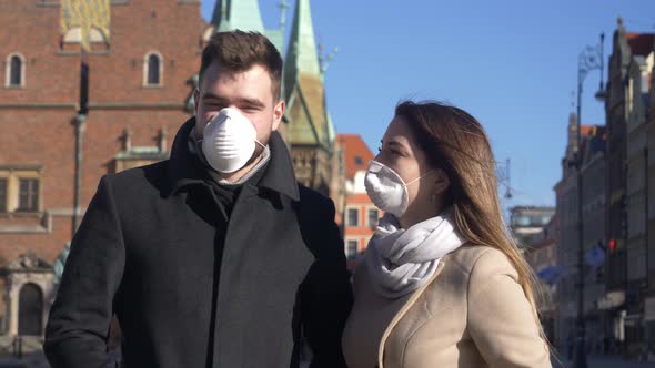 Young couple in masks on city street of Wroclaw, Poland