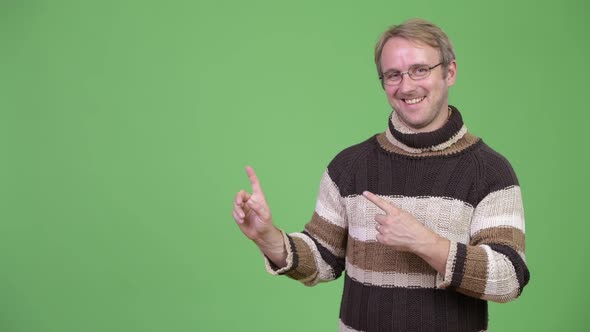 Studio Shot of Happy Handsome Man Showing Something