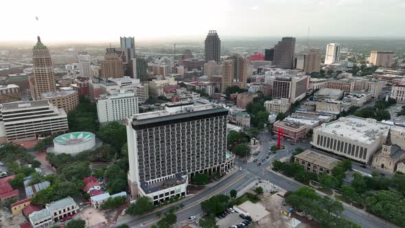 Cinematic wide aerial of San Antonio skyline and tourist attractions during sunset. Riverwalk area a