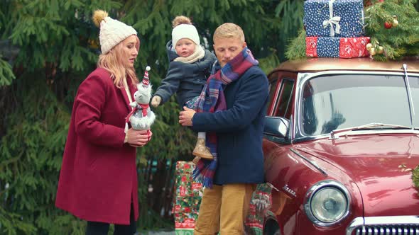 Family on the Background of a Retro Car