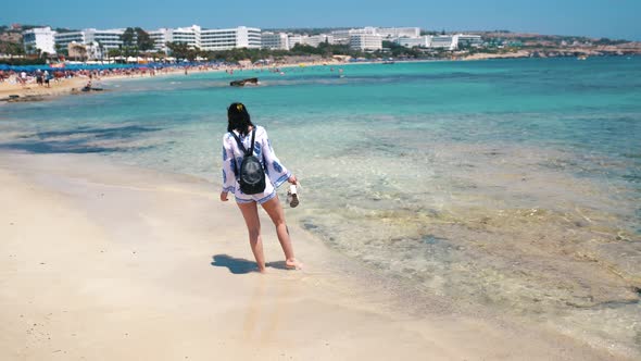 Beautiful Scene Of A Woman Walking On Ocean Beach