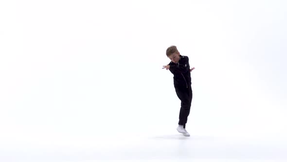 Little Boy Is Dancing a Modern Dance on the White Background in Black Leather Jackets and Jeans