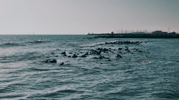 Waves Crashing Against Rocks on a Rocky Beach