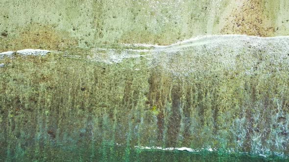 Aerial drone shot abstract of idyllic resort beach adventure by aqua blue lagoon with white sandy ba