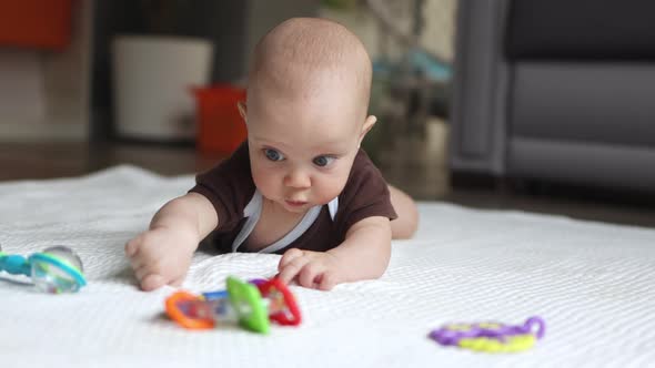 Little Baby Infant Learning Crawl on the Floor Living Room Trying Reach Toys