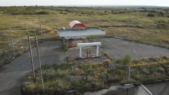 Aerial View of Derelict Gas Station Next To the Road. Abandoned Petrol Station with No Fuel Signs