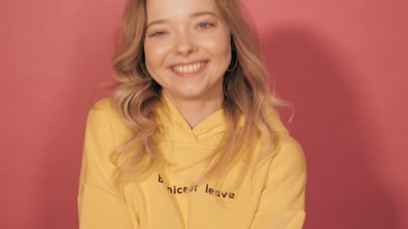 ttractive girl posing in studio near pink wall