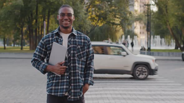 Young Successful African American Guy Wearing Sunglasses Male Business Man with Laptop Smiling