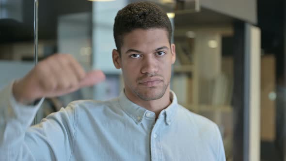 Serious Young African Man Showing Thumbs Down