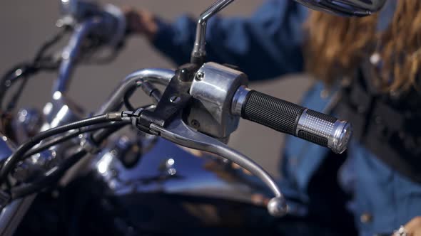 Female Hands on Motocycle Steering Wheel