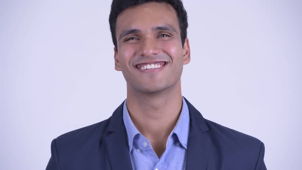 Face of Happy Young Indian Businessman in Suit Smiling