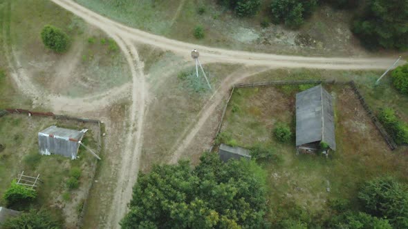 Crossroads Of Unpaved Rural Roads. In The Center Of The Intersection Is A Nest With Storks