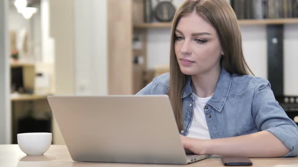 Pensive Creative Woman Thinking and Working on Laptop