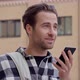 Man holding mobile phone and talking. - VideoHive Item for Sale