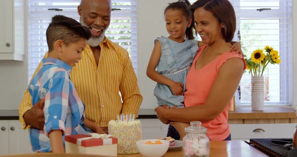 Front view of black family celebrating birthday in kitchen of comfortable home 4k