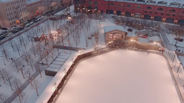 Aerial View of Outdoor Skating Rink in the New Holland Park in a Snowy Winter Evening Night