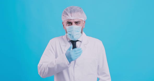 Sick Doctor, Viral Infection. Male Doctor in Protective Medical Mask and Disposable Cap Coughing