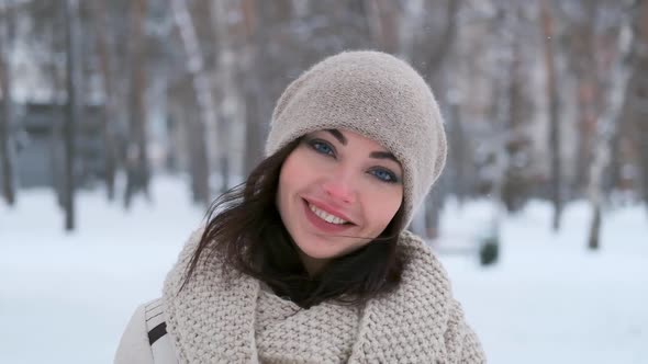 Portrait of a Young Girl Walking in the Winter Forest Who Is Smiling