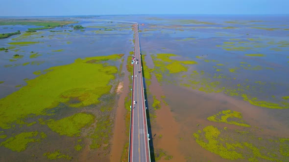 Drone video of the road leads through a large beautiful wetland.