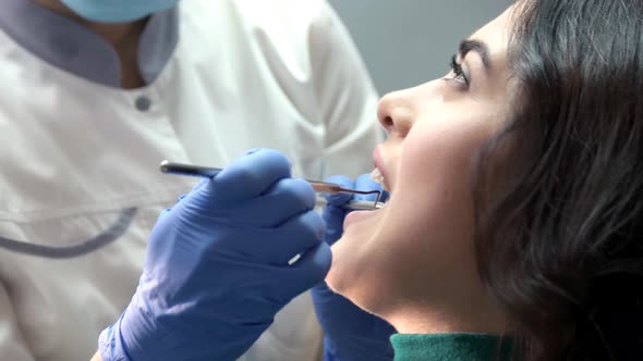 Dentist in Gloves Examining Patient.