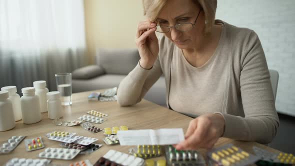 Female Putting Glasses and Reading Medicine Instruction, Pharmaceutical Industry