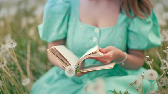 Hands of Woman Turns Over Pages of Old Paper Book