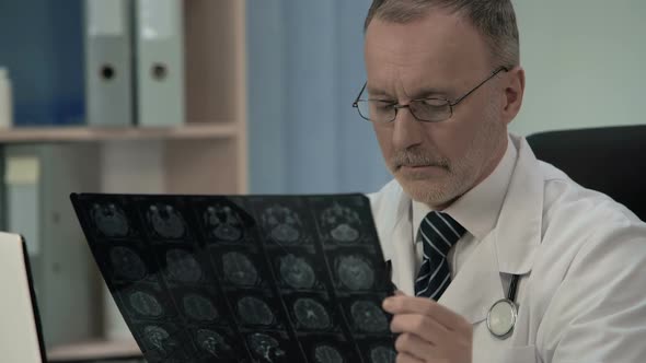 Neurologist Checking MRI Image, Confirms Pathology in Patients Cerebral Cortex