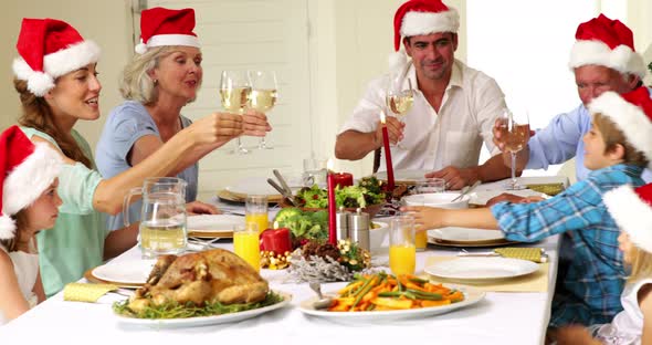 Extended family toasting at christmas dinner 4k