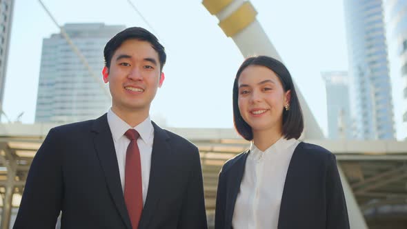 Portrait of Asian smart business woman and man work in company office in city and look at camera.