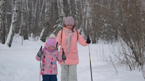 Child Girl with Mother CrossCountry Skiing