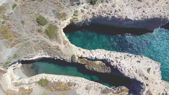 Beautiful beach and coastline of Papafragas with caves and cliffs formed by volcaninc activity, Milo