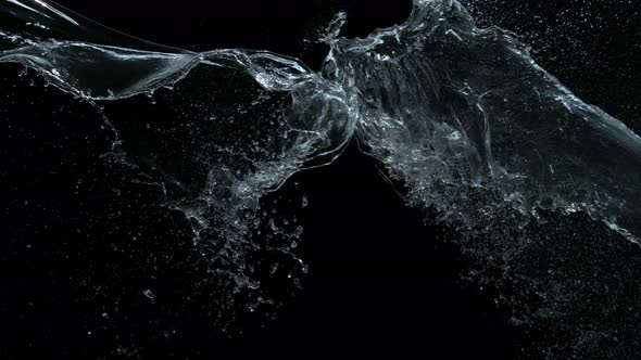 Super Slow Motion Shot of Water Splashes Crashing on Black Background at 1000Fps alt