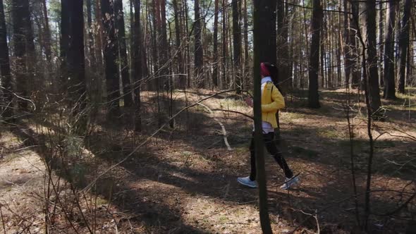 Girl runner runs in the park goes for sports. runner athlete girl running on trail nature.