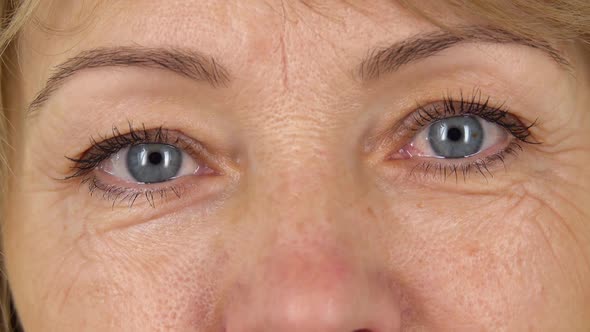 Woman Blue Eyes with Wrinkles Looking Straight Close Up