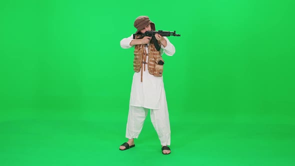 An Armed Man of Arab Appearance Raises an Assault Rifle and Takes Aim a Chroma Key Template