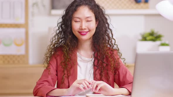 Smiling young Asian girl looking at camera. Happy confident beautiful smart young adult entrepreneur