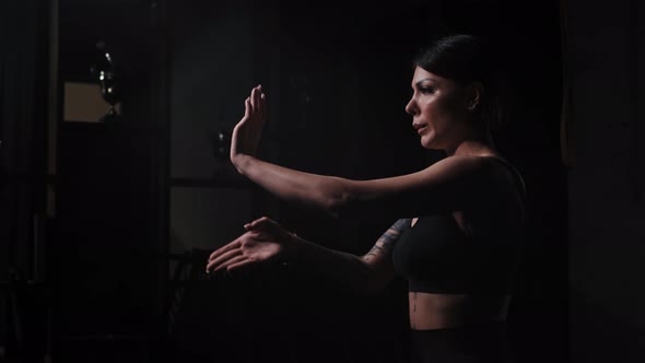A Strong Tattooed Woman Showing Karate Fighting Hands Moves