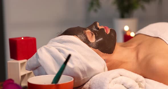 Woman with Face Mask Cucumber Slices Put on Face in Spa