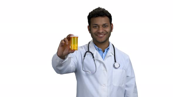 Young Smiling Doctor Showing Pills and Thumb Up