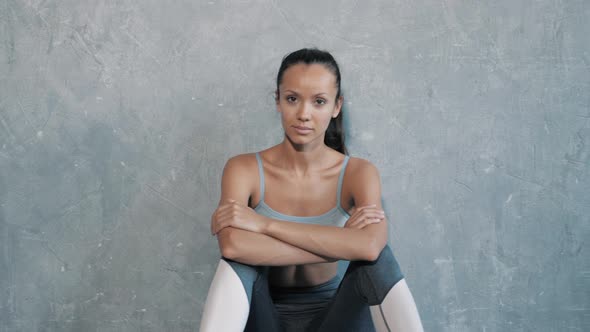 Pretty woman wearing sportswear.Beautiful girl after training in studio