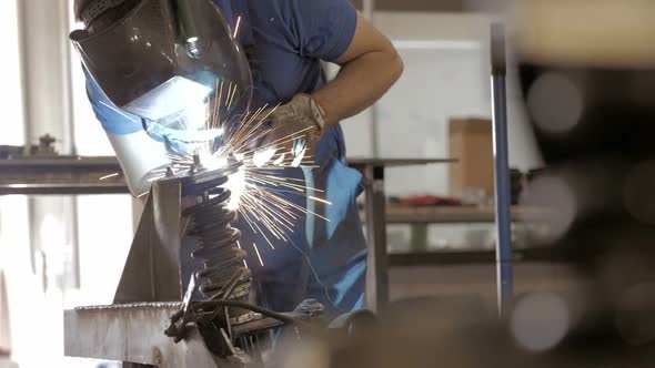 Welder Worker Hand Welds Metal Constructions. Workman In Workshop. Welding Process