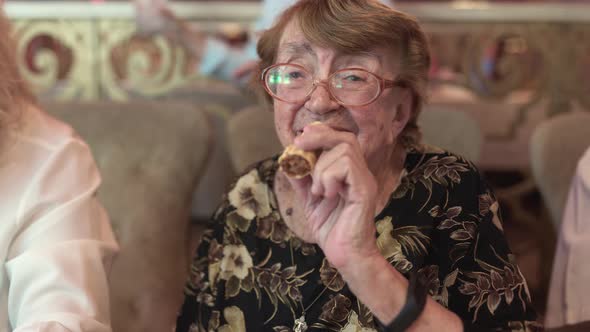 Elderly woman having dinner with family at the restaurant